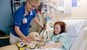 “I enjoy bringing my dog to work every day and being able to bring out a smile,” says Jane Nolan, of Maddie, pictured here at Children’s Medical Center as part of their 'Paws of Hope' program.