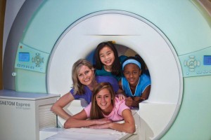 Pictured here, young friends check out the spacious MRI at Envision Imaging.