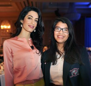 “I want the public to know that we as youth have a voice,” says Sammie, shown here with Keynote Speaker Amal Clooney at the New Friends New Life Wings luncheon in April, where she spoke without any notes to 1700 guests. Clooney was so impressed with Sammie’s eloquence that she told the audience she had already offered her a job once she graduates from college.