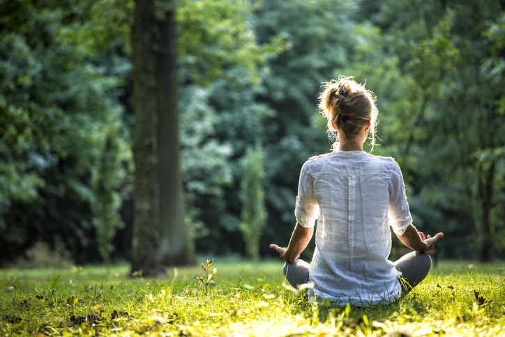 woman meditating in the park
