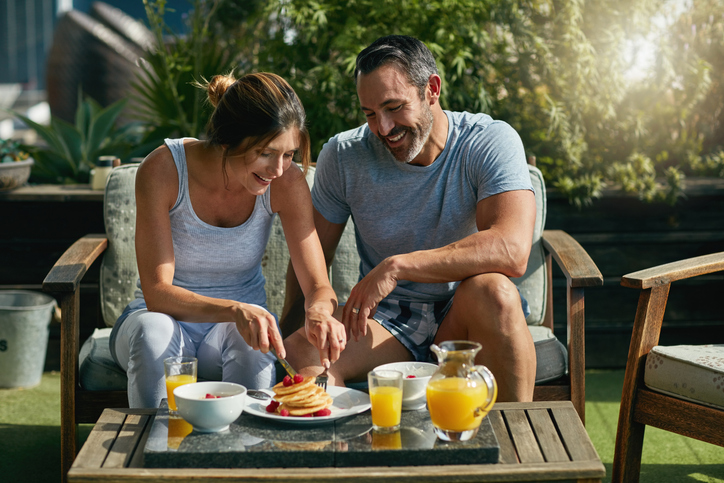 Shot of a mature couple enjoying breakfast together outdoors